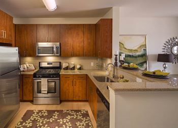 Well-equipped kitchen w/ custom cherry cabinetry